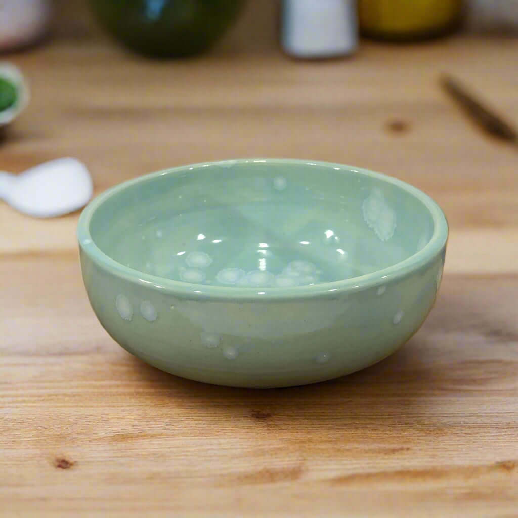 Beautiful modern bowl, 15cm wide, glazed with a turquoise Celadon glaze that has white blooming crystals.