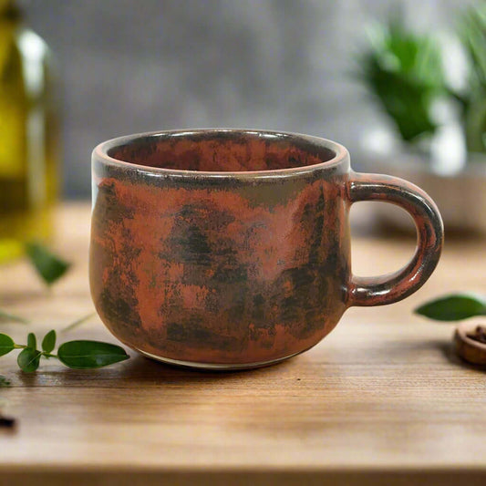 Small modern coffee or tea cup, 7cm tall and finished with burnt copper glaze