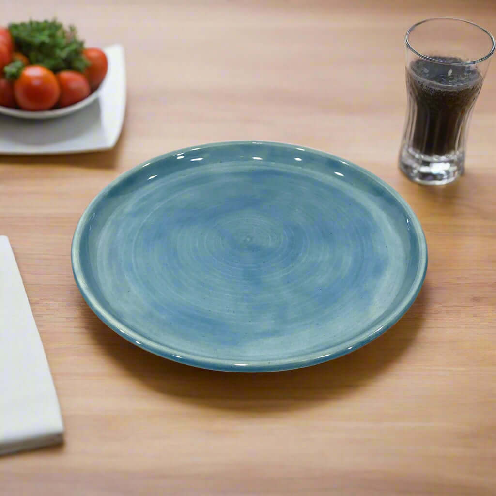 Modern dinner plate, glazed in a soft blue Celadon, 25cm wide
